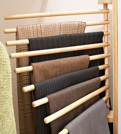 a rack with several different colored fabrics on it