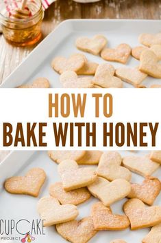 heart shaped cookies on a plate with honey in the background and text overlay reading how to bake with honey