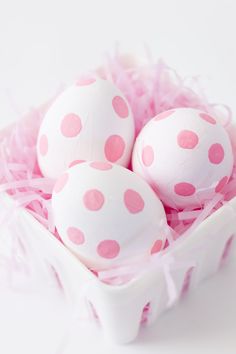 pink and white polka dot eggs in a basket