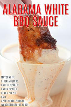 a person dipping something into a bowl with sauce on it and the words, alabama white bbq sauce