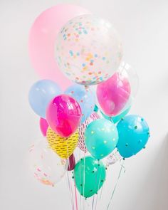 a vase filled with balloons and confetti