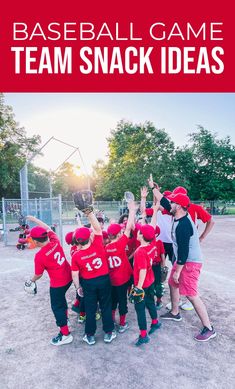 the baseball team has their hands in the air and is holding up a trophy while wearing red