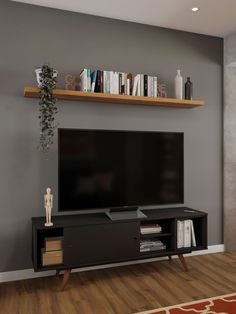 a flat screen tv sitting on top of a wooden entertainment center in a living room