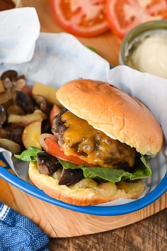 a hamburger with lettuce, tomato and mushrooms on it