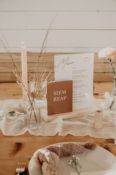 the table is set with an elegant menu and place setting