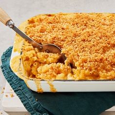 a casserole dish with macaroni and cheese in it on a blue towel