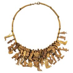 an old necklace with gold colored metal pieces and figures on it's neckline