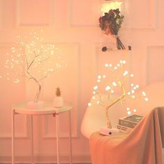 a white table and chair in a small room with lights on the wall behind it