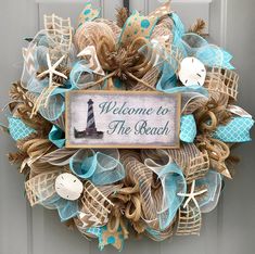 a welcome to the beach wreath on a door