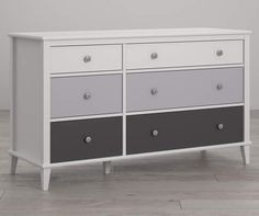 a white, grey and black dresser with four drawers on the bottom shelf in a room