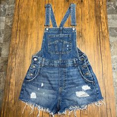 Blue Jean Bib Shorts Never Worn Size 8 High Waist Blue Overalls With Pockets, Medium Wash Overalls For Summer, Blue Short Length Overalls For Summer, Blue Short Summer Overalls, Blue Short-length Summer Overalls, Blue Short Length Summer Overalls, Blue Summer Overalls, Blue Denim Overall Pants, Blue Denim Overalls