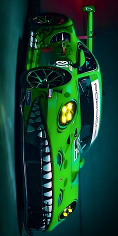 a green race car with its lights on