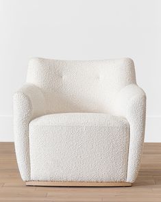 a white chair sitting on top of a hard wood floor