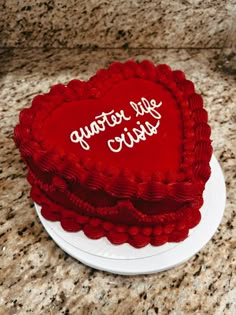 a red heart shaped cake with the words happy valentine's day written on it