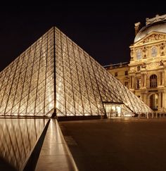 the glass pyramid is lit up at night