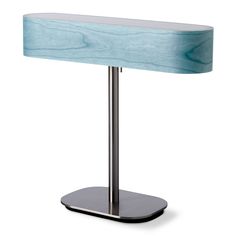 a table lamp with a blue shade on the top and silver base, against a white background