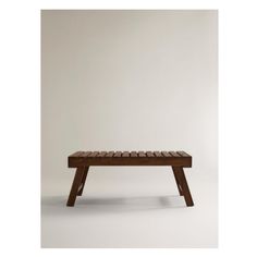 a wooden bench sitting on top of a white floor