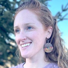 a close up of a person wearing earrings