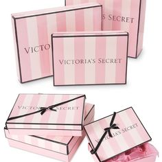 three pink boxes with black bows and the words victoria's secret written on them