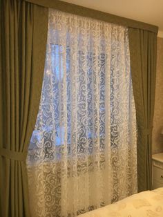 the curtains in this bedroom are drawn up to look like they have been drapes pulled back