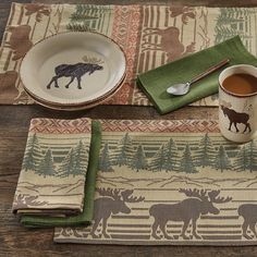 the moose placemats are next to a cup of tea