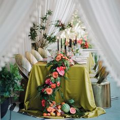 an image of a table setting with flowers and candles on it for a wedding reception