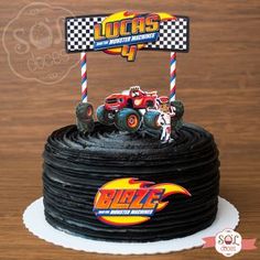 a birthday cake with monster trucks on top