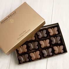 a box of chocolates sitting on top of a white table