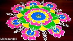 a colorful flower design on a wooden surface