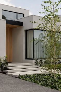 a modern house with steps leading to the front door