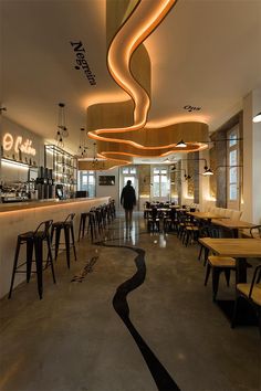 the interior of a restaurant with tables and chairs