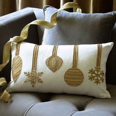 a pillow with ornaments on it sitting on a couch