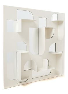 an abstract white wall sculpture with shelves and mirrors on each side, in the shape of a rectangle