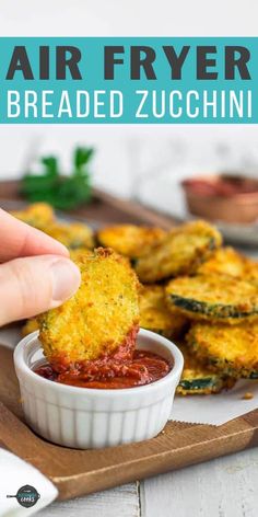 a person dipping sauce on zucchini chips in a small white bowl with text overlay that reads easy air fryer zucchini chips