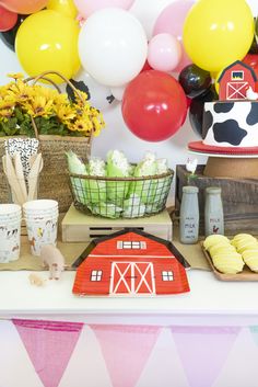 a farm themed birthday party with balloons and cake