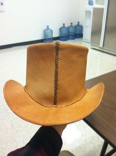 a cowboy hat sitting on top of a wooden table