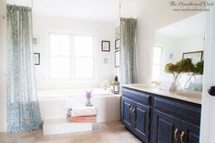 a bathroom with blue cabinets and white walls