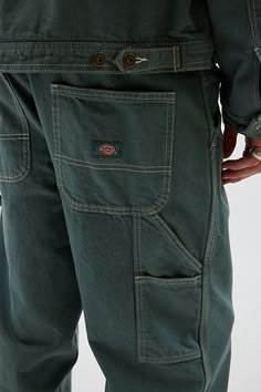 Easy mid rise carpenter pants by Dickies in a straight leg silhouette. Classic carpenter style pants with utility pockets and a hammer loop accent. Features Dickies Stevensville carpenter pants Utility pants from Dickies Stonewashed cotton Mid rise waist Utility pockets Hammer loop Straight legs Content + Care 100% Cotton Machine wash Imported Size + Fit Model in Taupe is 6’1" and wearing size 32 Measurements taken from size 32 Rise: 11" Inseam: 31" Leg opening: 10" | Dickies Stevensville Carpenter Pant in Dark Green, Men's at Urban Outfitters Dickies Corduroy Pants, Cool Mens Pants, Men’s Pants, Mens Dark Fashion, Mens Punk Fashion, Jasper Aesthetic, Art Office Ideas, Guy Pants, Mechanic Fashion