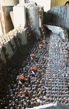 a very large group of legos in a room with people looking at them from above