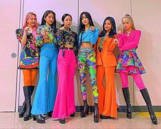 the models are posing in colorful outfits