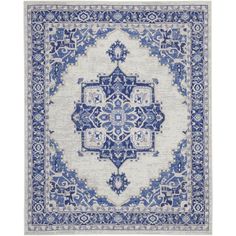 a blue and white rug with an intricate design on the middle, in front of a white background