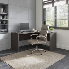 an office area with a desk, chair and bookcase in grey tones is shown