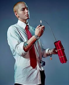 a man in a red tie is holding a lighter