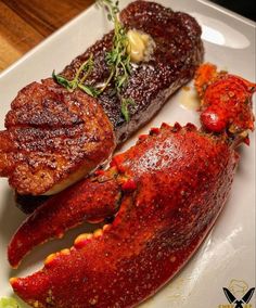 three different types of lobsters on a white plate with garnishes and herbs