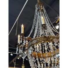 a chandelier hanging from the ceiling in a room with many lights on it