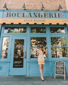 a woman standing in front of a cafe