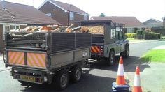 the truck is loaded with logs and other things to be picked up from the yard