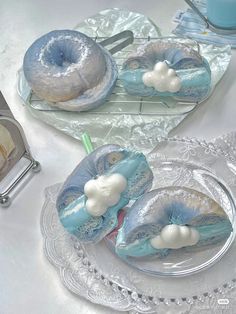 there are two blue and white cakes on the plates