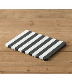 a black and white striped coaster sitting on top of a wooden table