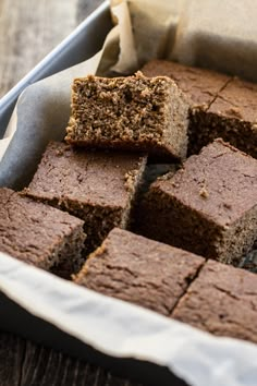 a pan filled with brownies sitting on top of a wooden table